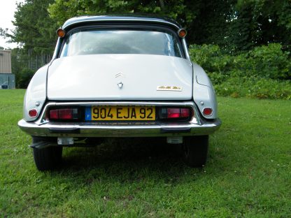 A 1971 Citroen DS 21 Euro Spec parked in a grassy area.