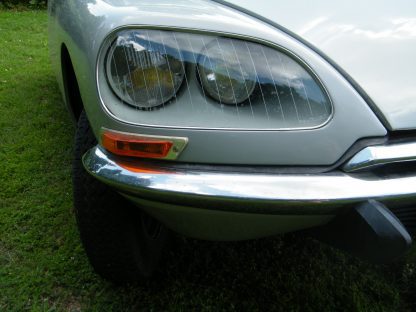 A 1971 Citroen DS 21 Euro Spec parked in a grassy area.