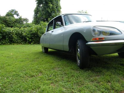 A 1971 Citroen DS 21 Euro Spec parked in the grass.