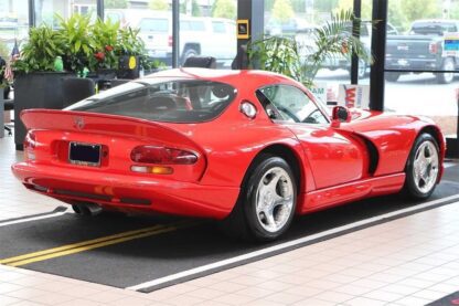 A 1997 Dodge Viper GTS sports car is parked in a showroom.
