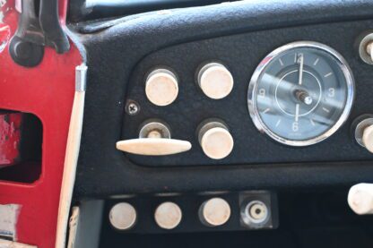 A close up of the dashboard of a red truck.