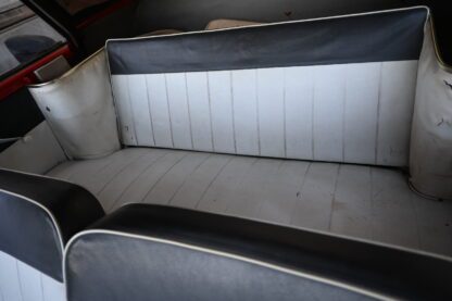 The interior of a car with black and white seats.
