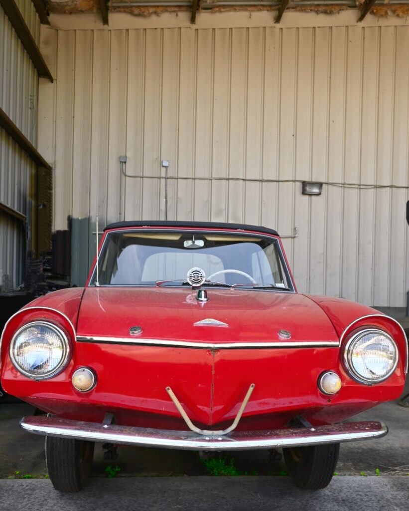 A red car parked in a garage.