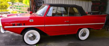 An old NO RESERVE - - - 1967 AMPHICAR - - - NO RESERVE parked in a garage.
