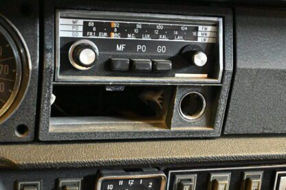 A close up of a radio in a car.