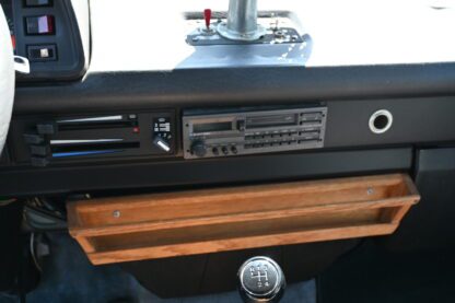 A wooden tray in the center of a car.